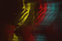 Multiple exposure of young woman covering her mouth in shadow with color effect